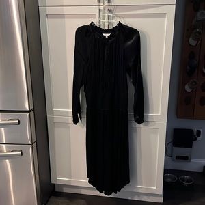 Black silky/satin dress with elasticized waist. Button close at top.